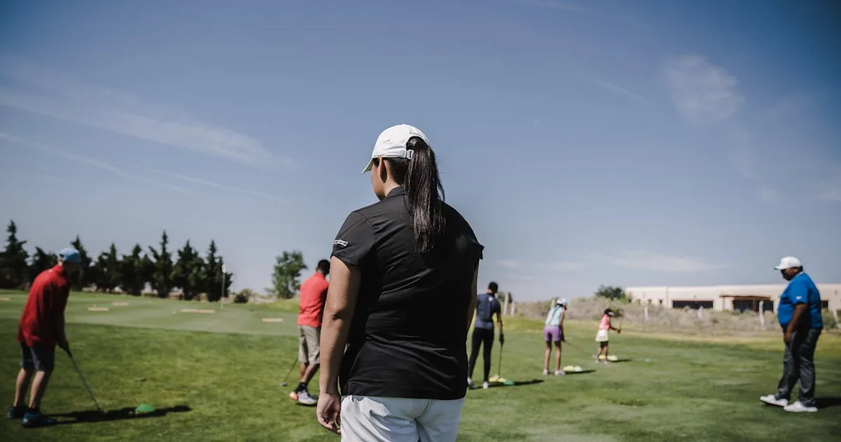 Beginners enjoying a group golf lesson on a bright day at the course