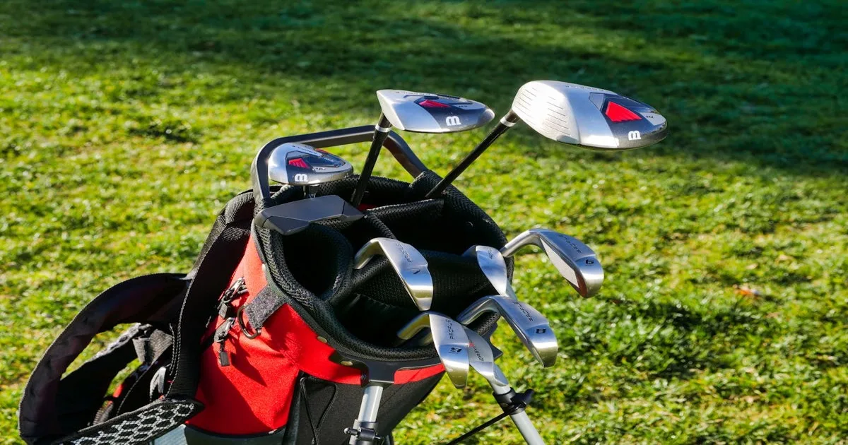 A well-used golf bag with clubs on a lush green fairway