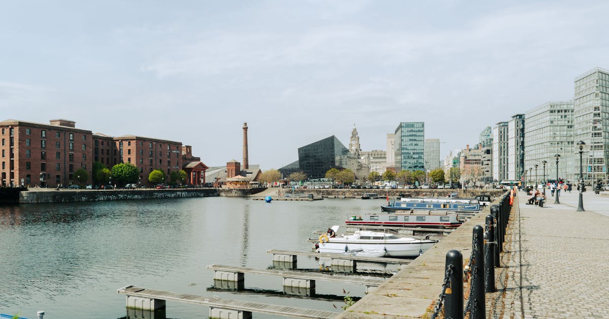 Liverpool waterfront with docked boats and iconic city architecture