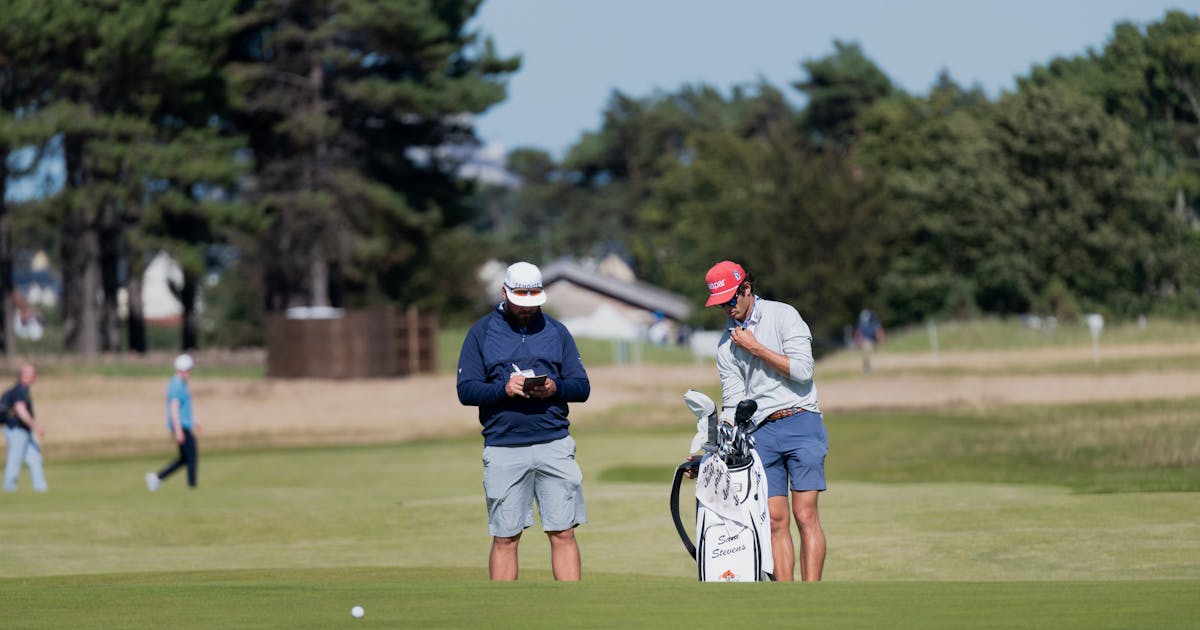 Two golfers on a sunny Scotland golf course with rolling green fairways