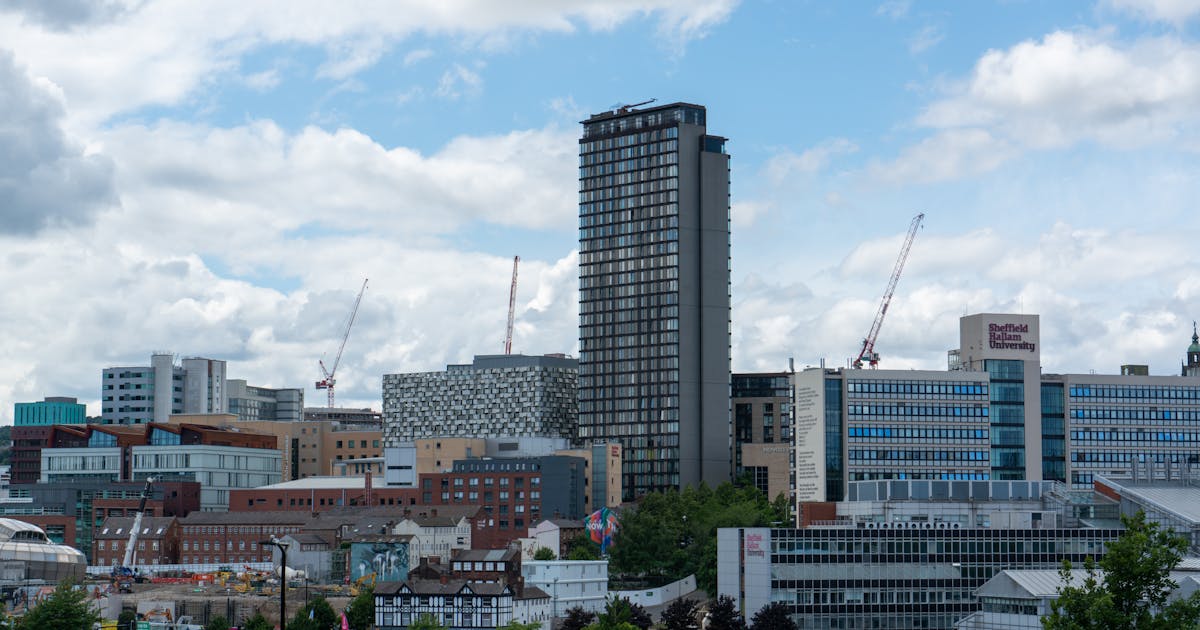 Sheffield city centre skyline with the Peak District hills visible in the distance