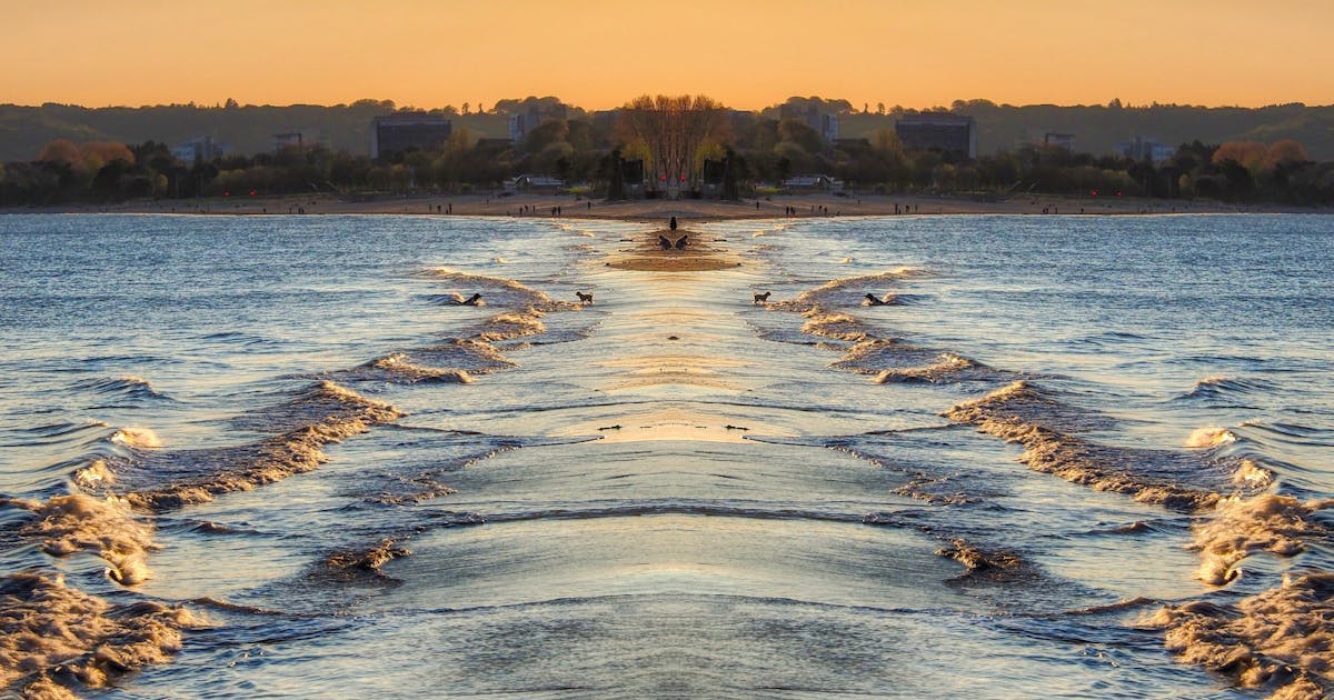Swansea Bay seafront with the city skyline and Gower Peninsula in the background